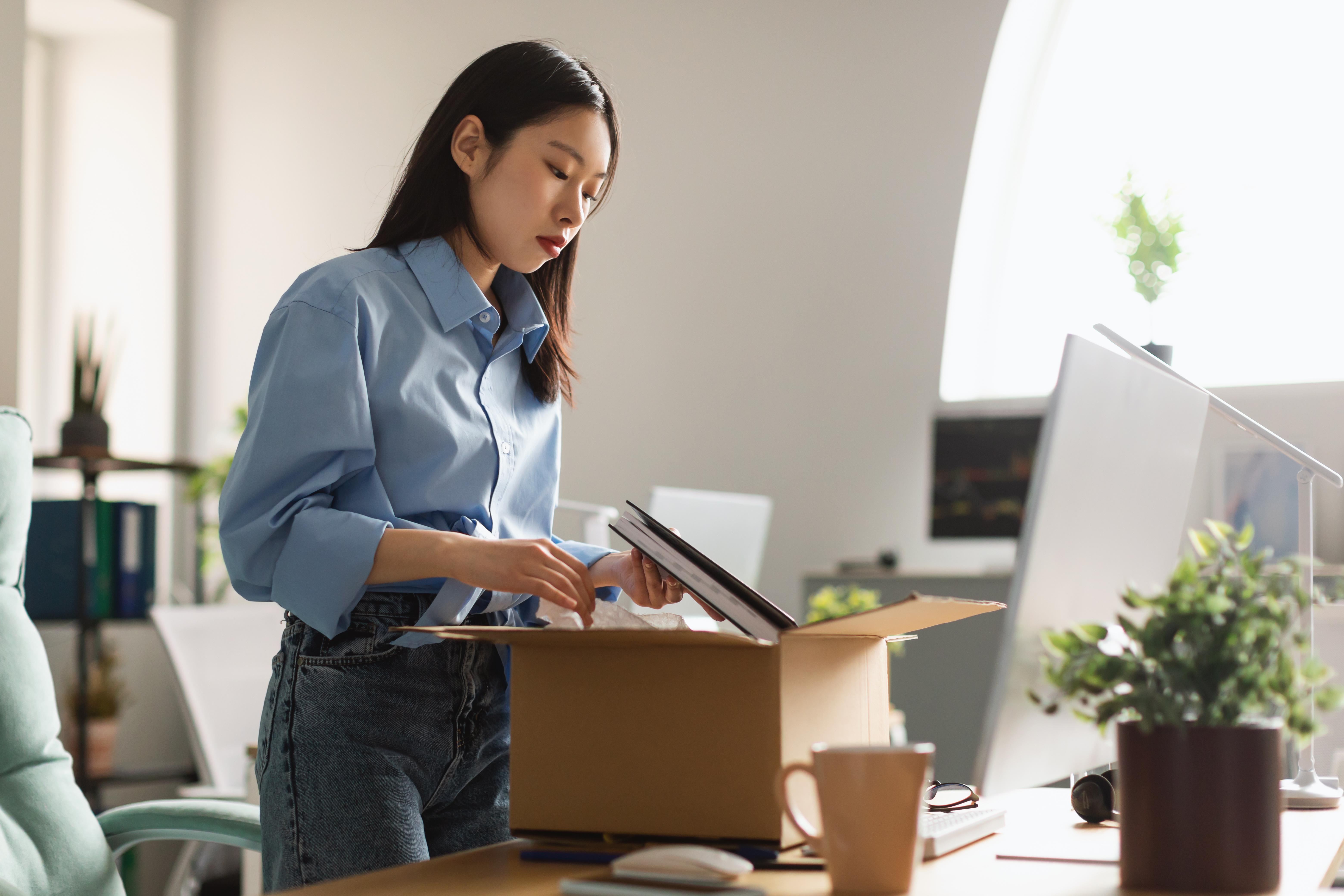 woman putting items in a box