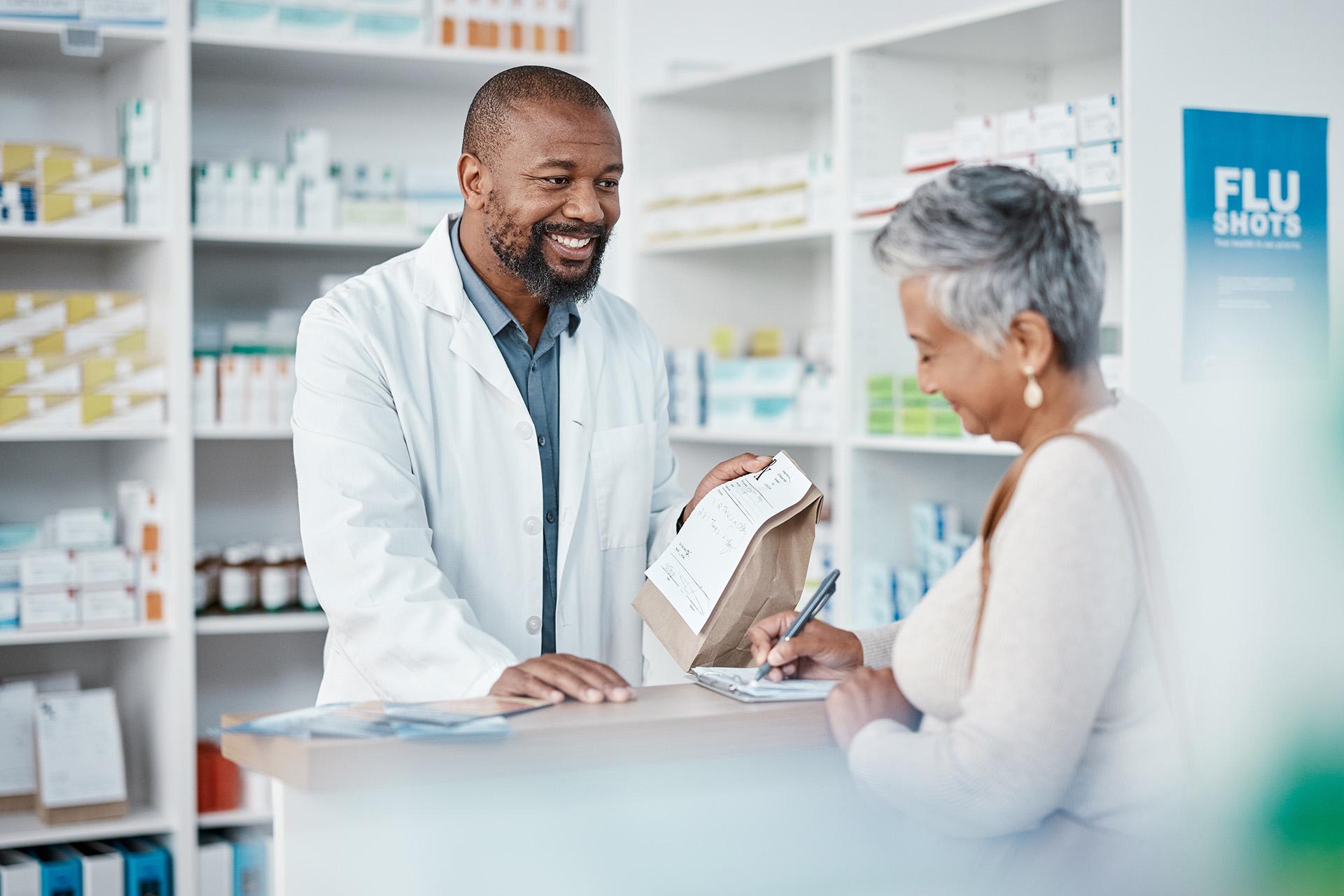 Pharmacist handing customer their prescription