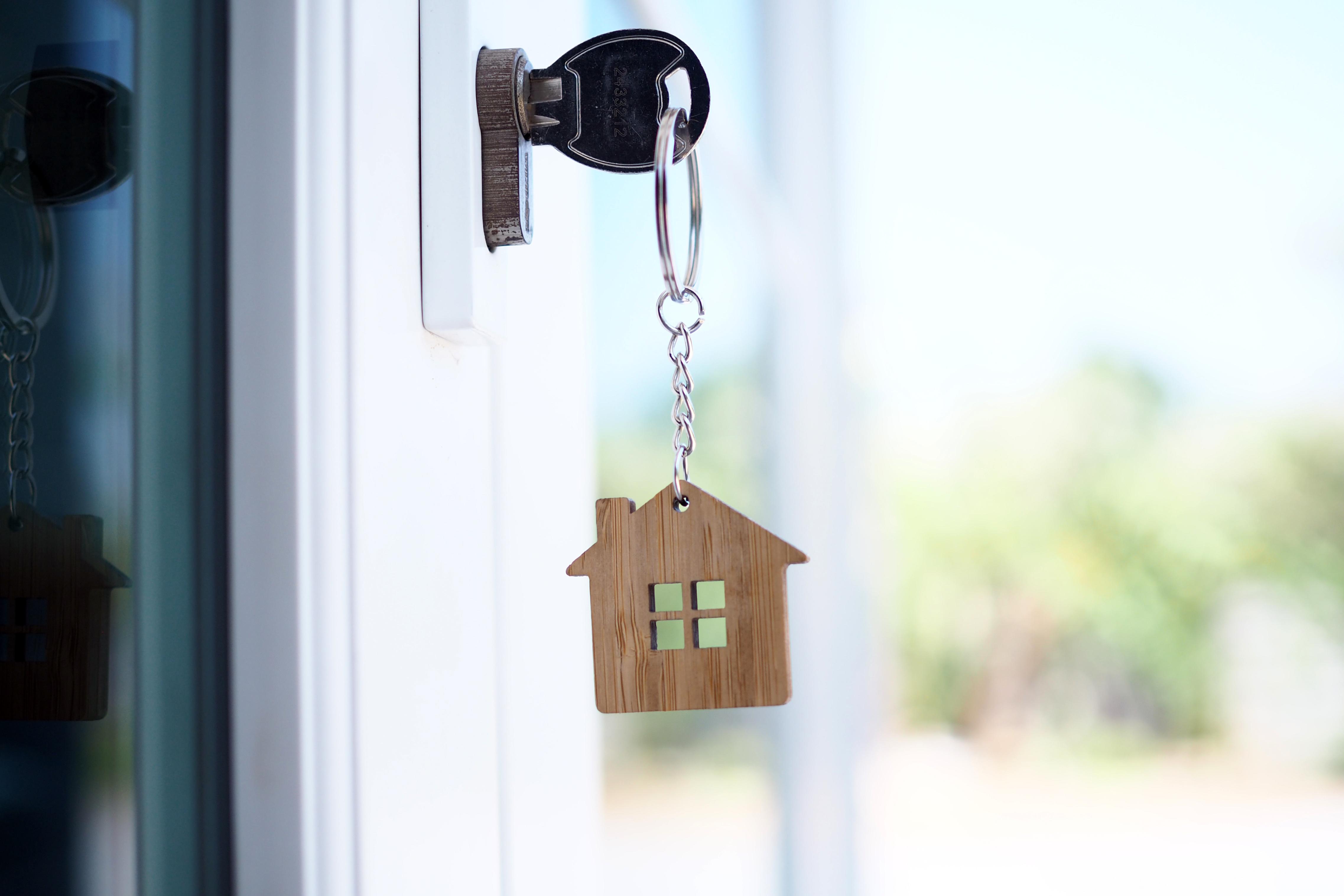 key with house keychain in lock of door