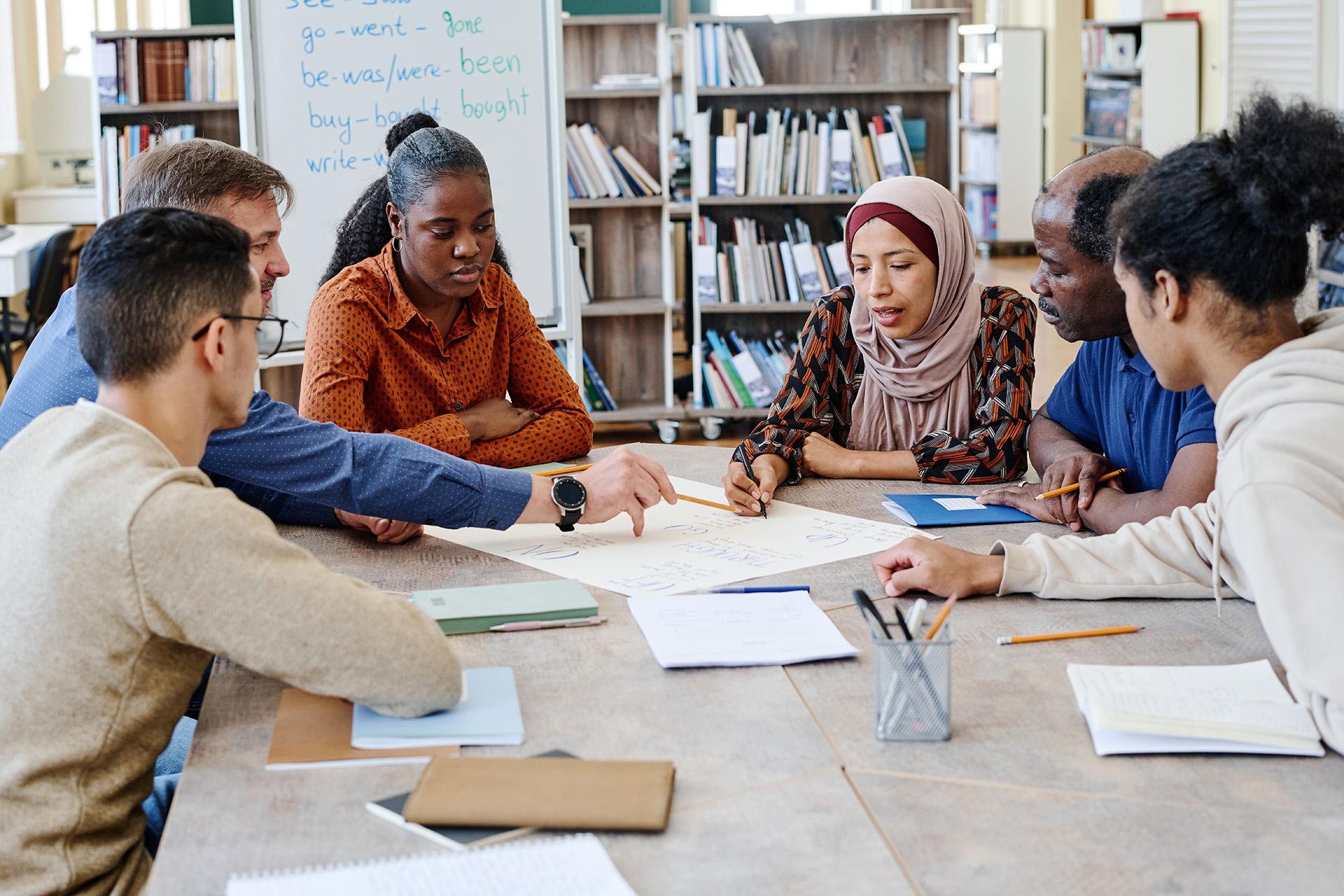 Group of staff collaborating around a central table